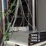 three AIT-KMS servers within the laboratory. In the background QKD devices by different manufacturers can be seen, that are within the same test network.